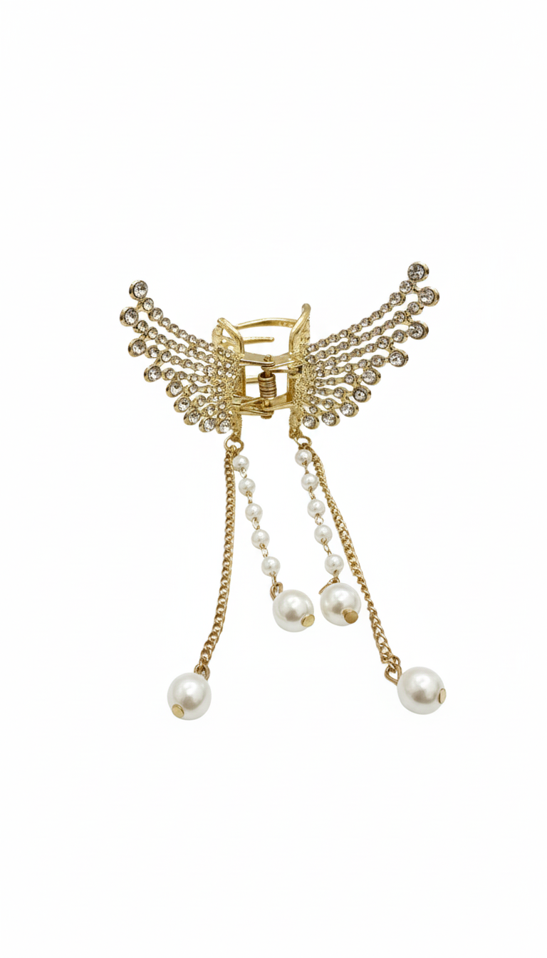 Decorative hair clip with gold accents and pearl beads on a white background