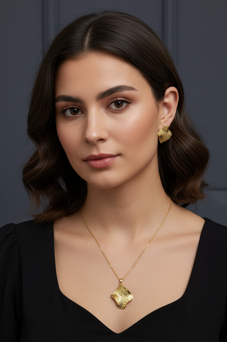 Woman wearing gold jewelry against a dark background