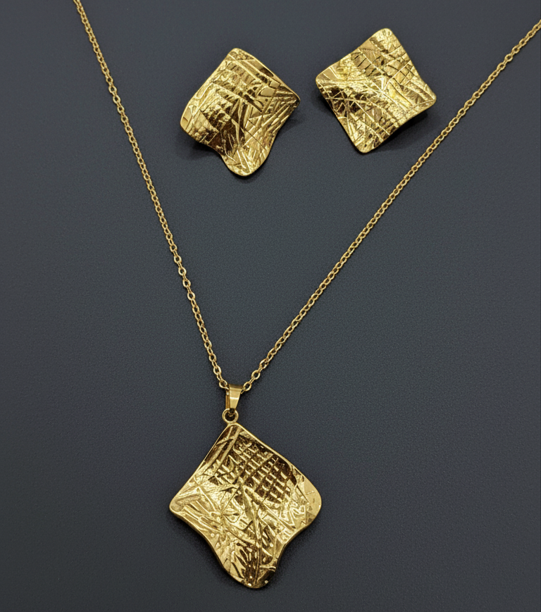 Gold necklace and earrings on a dark gray background